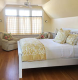 White painted walls and bed with hardwood floor
